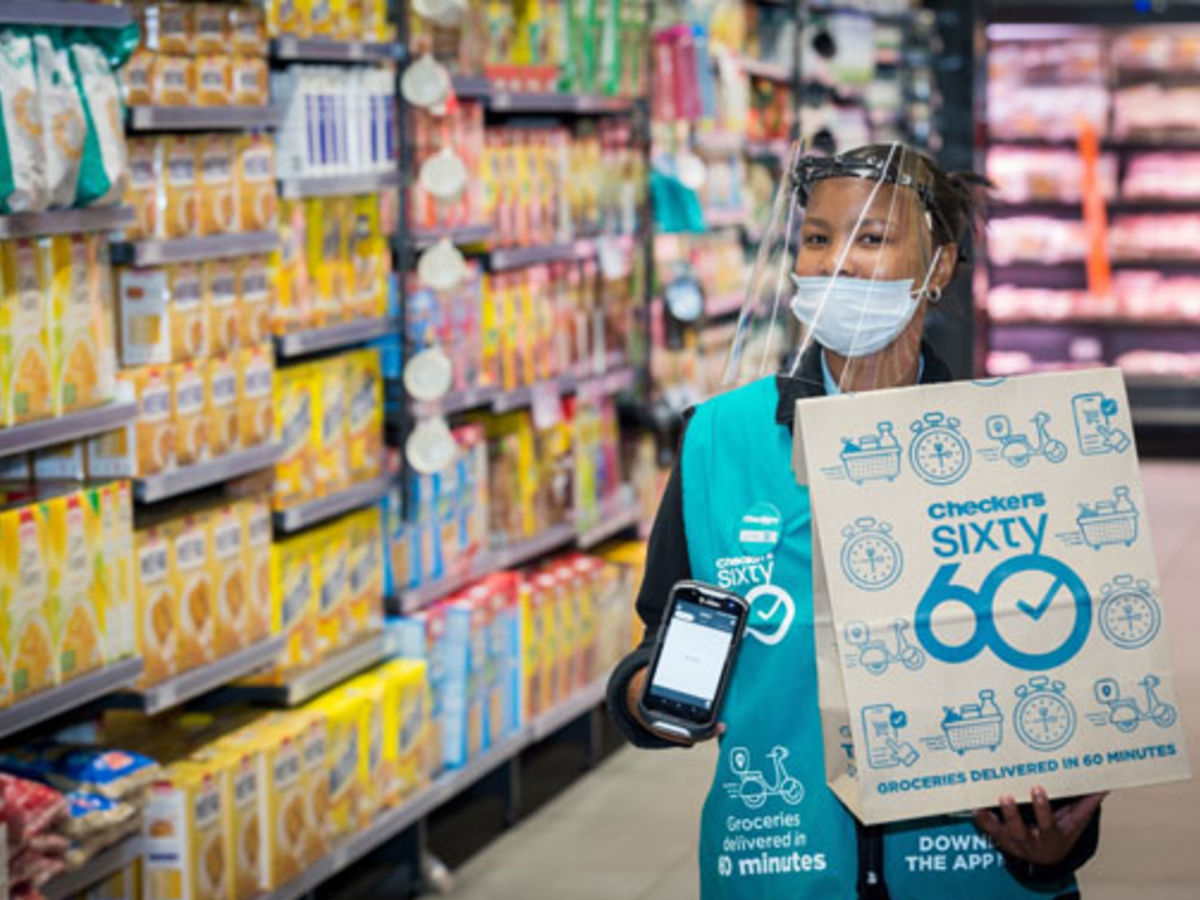 Checkers employee carrying a Checkers 60 60 bag in a shopping isle.